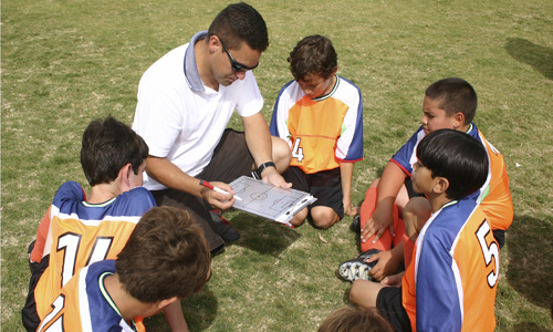 Coach talking to sports team